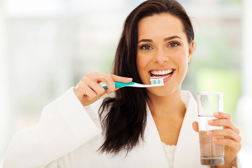 cute woman brushes her teeth