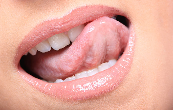 Young woman's glossy pink lips